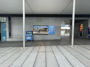 Facing venue straight ahead along back. Tall obstructing pole on either side.