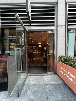 Single clear glass door. Pull vertical silver handle on right to open.