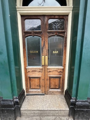 Large step leads to wooden framed glass doors. Push from centre to open.