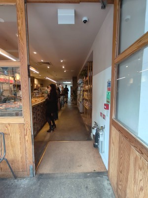 Facing entrance door. Pull handle on left of door to open.