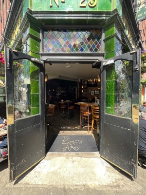 Black framed glass doors. Pull open via handles in centre.