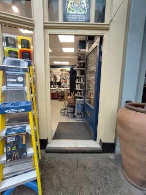 Blue framed glass door. Push silver handle on left to open.