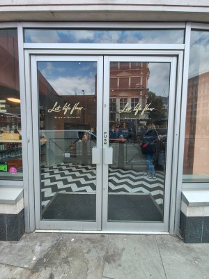 Facing entrance door. Push handles in centre to open.