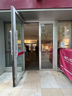Double glass doors with silver metal frame. Pull silver vertical handles in middle to open.