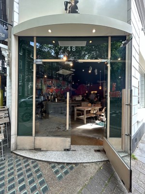 Double glass doors with vertical white handles along middle. Pull from middle to open.