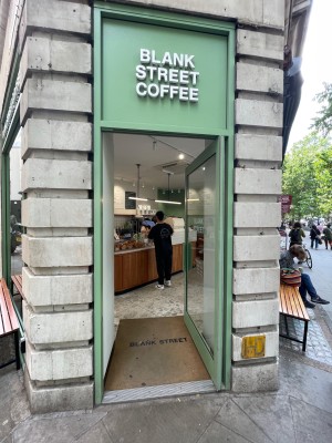 Green glass door with handle at left, push to open.