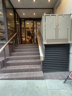 Facing entrance. Stairs on left. Platform lift on right.