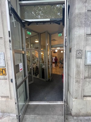 Grey framed glass doors. Pull from centre to open.