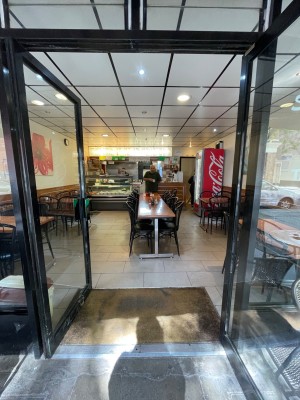 Black glass double door with handle in centre, push to open.
