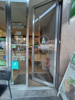 Facing entrance. Glass double door. Push handle on left of right door to open.