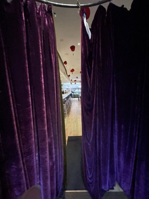 Velvet curtains exist separating the main entrance and the main front area.