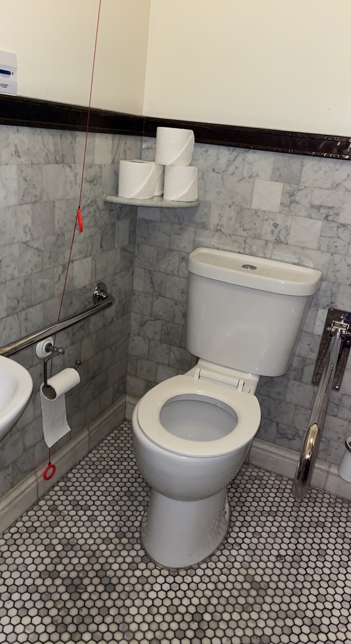 Red cord floor length. Extra bathroom roll to the top right.
