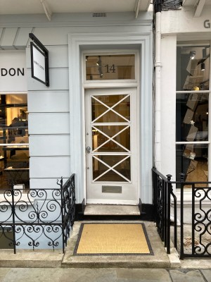 Path ahead to glass door with white frame on back. Push door to open via metal handle on left.