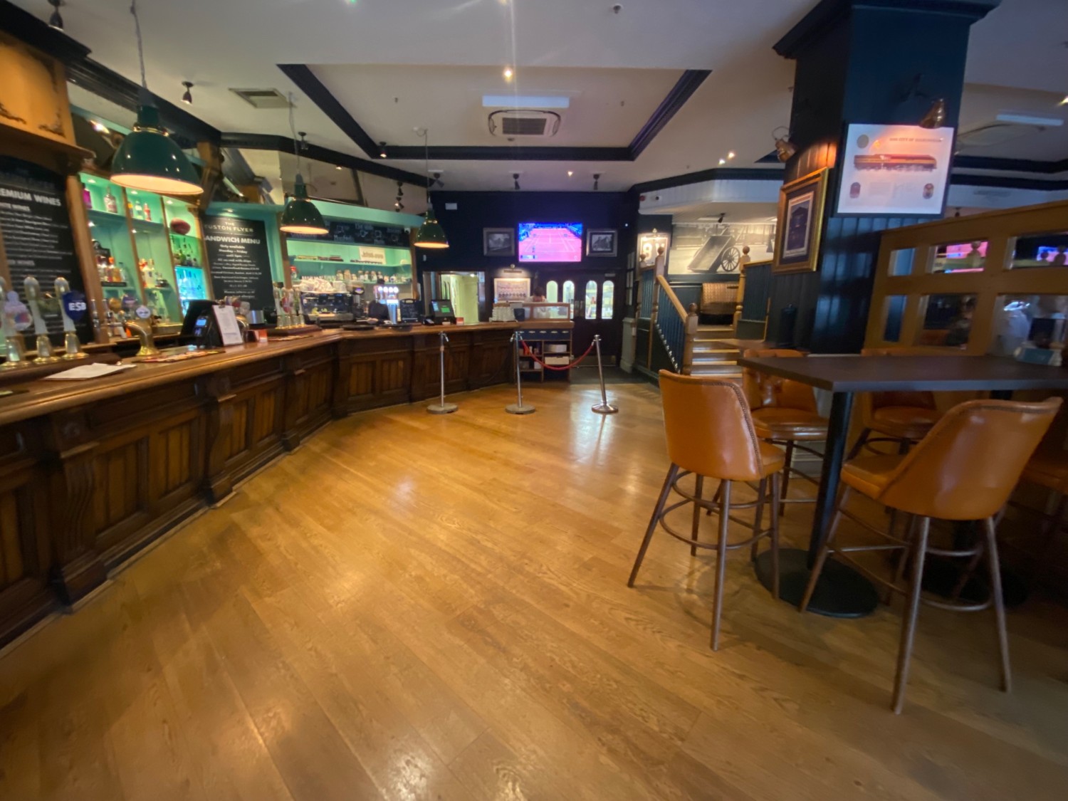 From counter, facing right. Counter along left. High table and stools on right.
