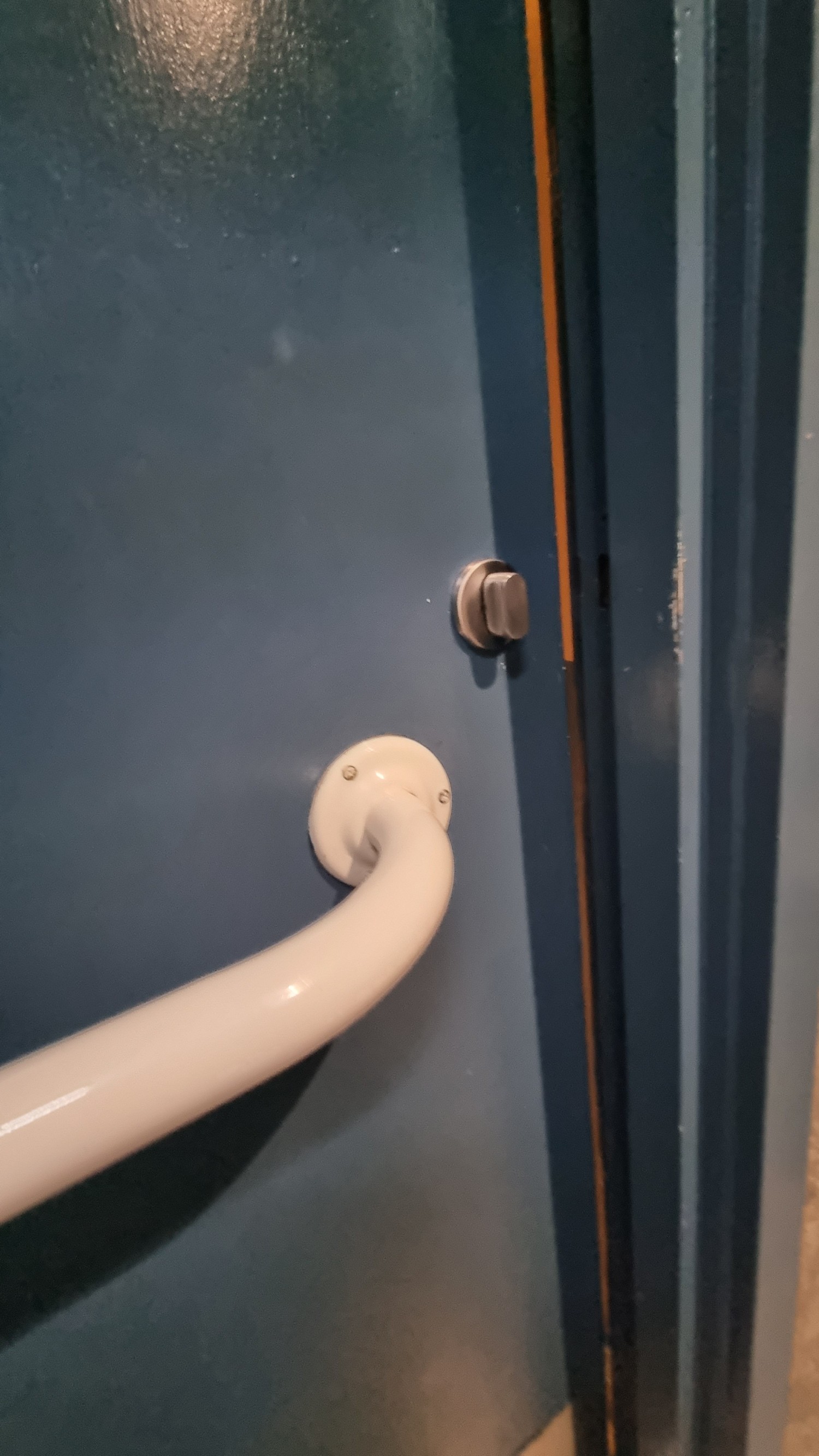 Turn lock. Two doors to access bathroom. Heavy doors so may need help