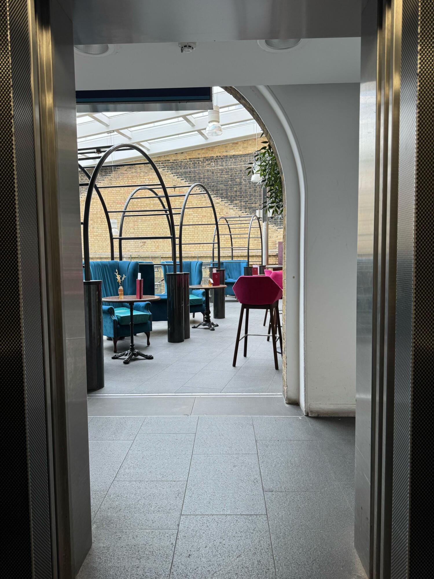 From lift facing straight. Path ahead to outdoor seating. Small bump at beginning of path.