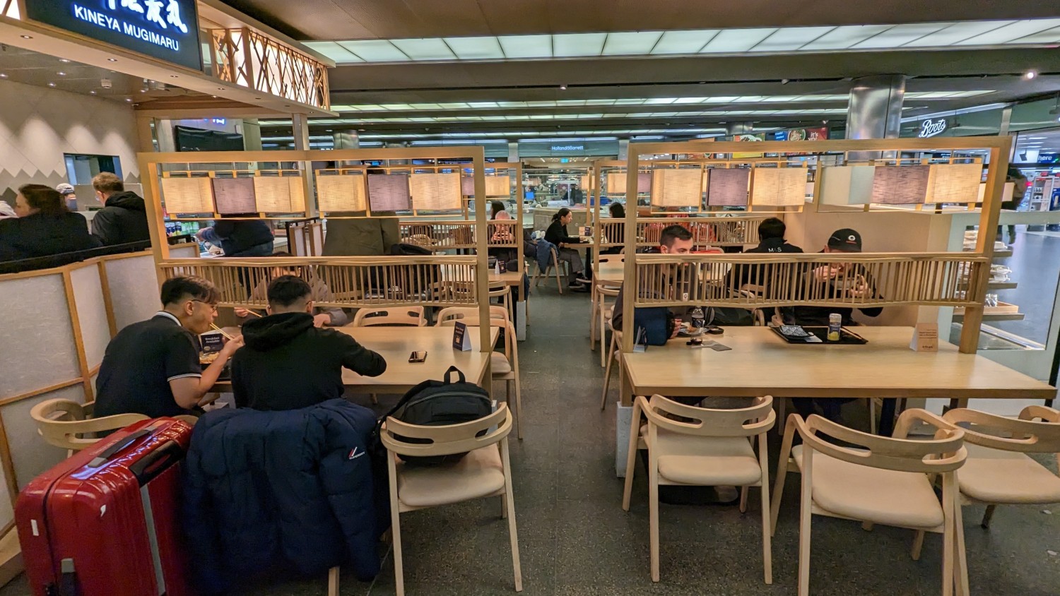From outside right of main entrance, facing straight. Rows of tables and chairs ahead. Path in-between.