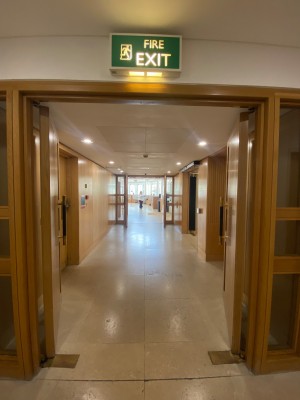 Double wooden door, black handles at centre of door. Push to open.