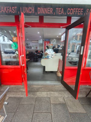 Red framed entrance door. Pull silver handles in centre to open.