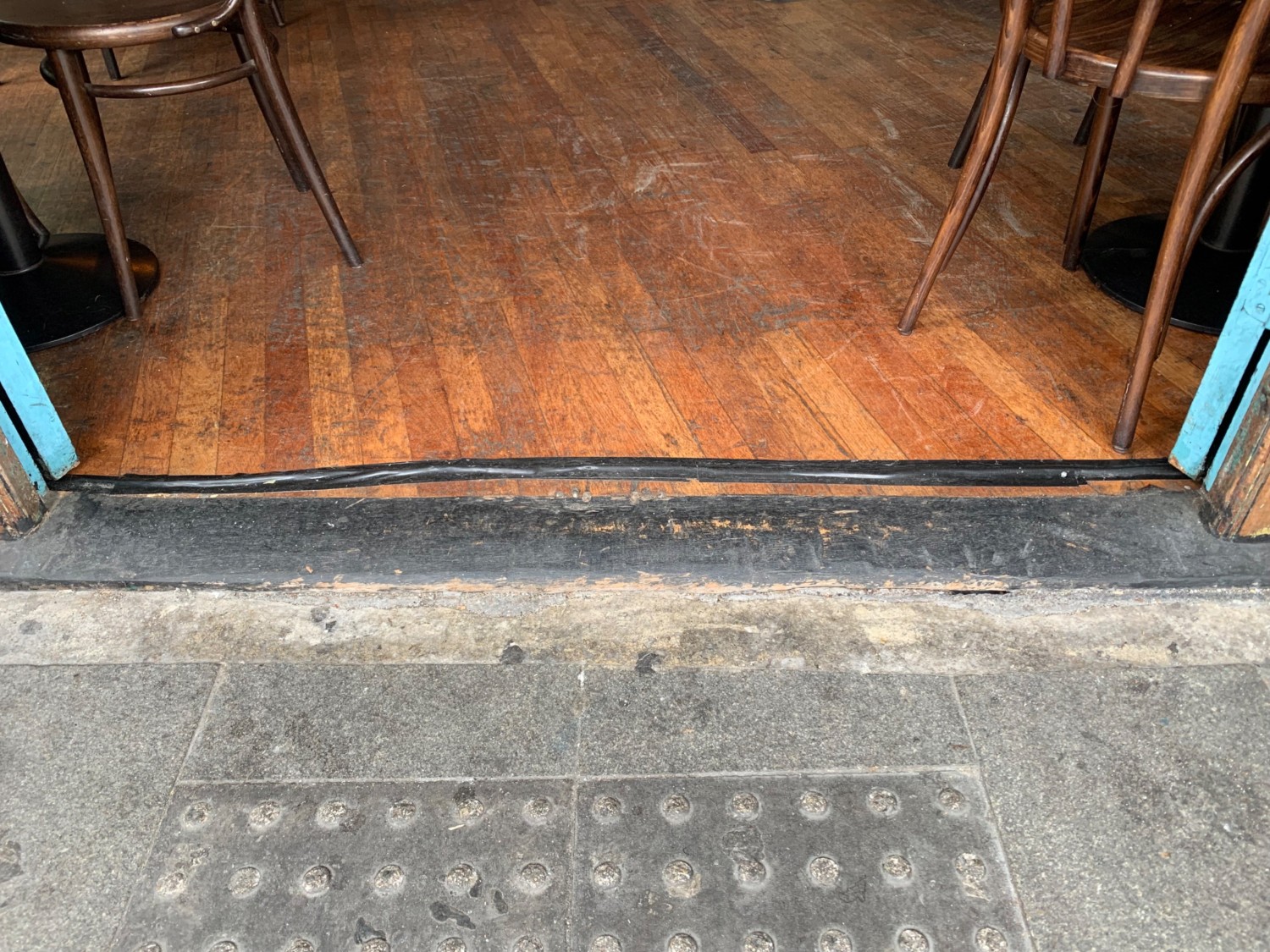 Two small bumps over threshold of doorway.