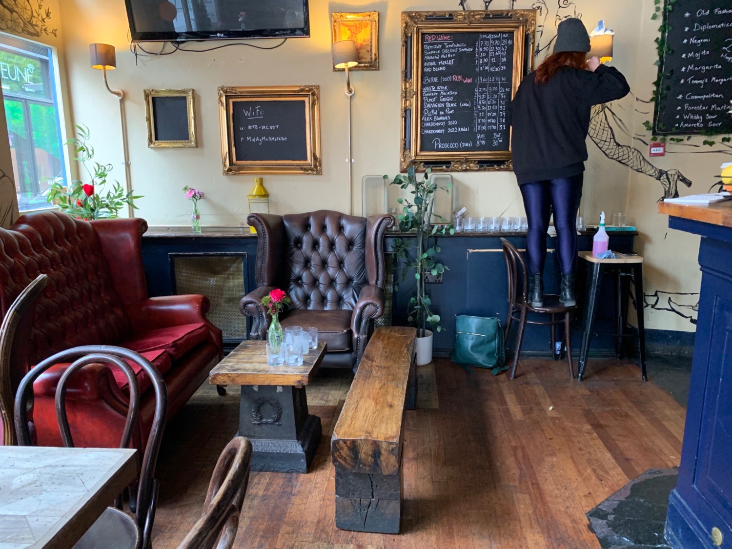From end of counter, looking straight. Couch, armchair, bench and low table ahead on left. Path straight. End of counter on right.