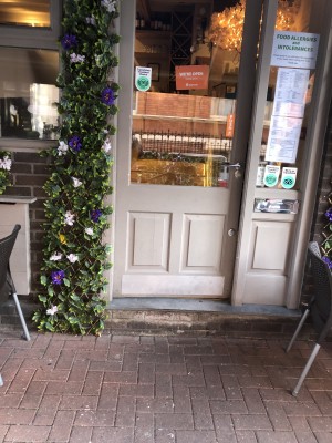 Photo of main entrance. Push handle on left to open. There is a small flight of stairs about a metre in to get to the main area and counter.