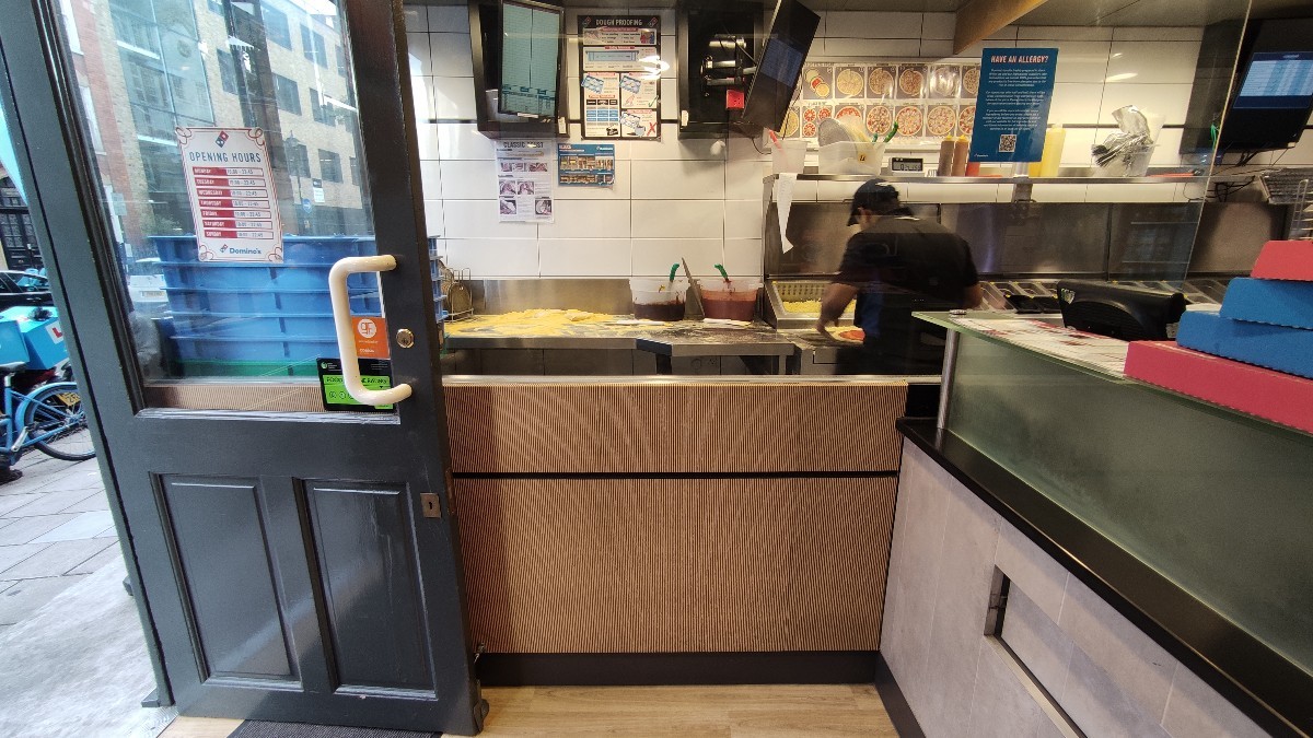 From door facing left. Open kitchen at the back. Counter to right.