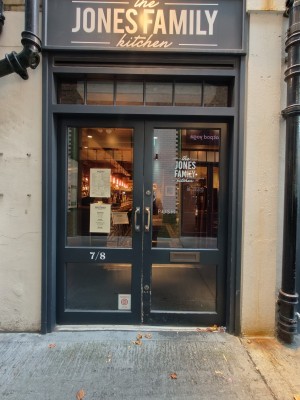 Facing black-framed glass doors. Pull brass handles in centre to open.