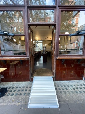Double wood and glass doors. Push golden handle from centre to open.