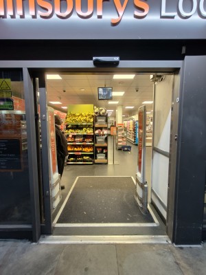 Grey-framed glass door ahead.