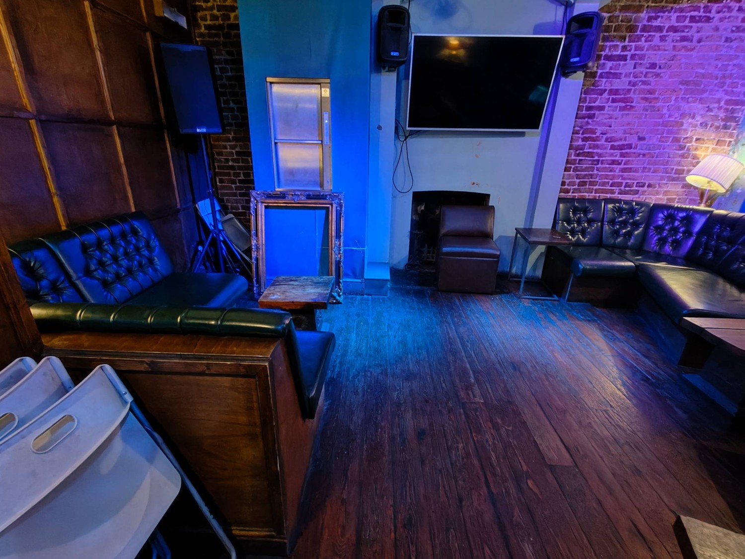 From door facing left. Couches along left. Path in centre going straight. Couches along right.