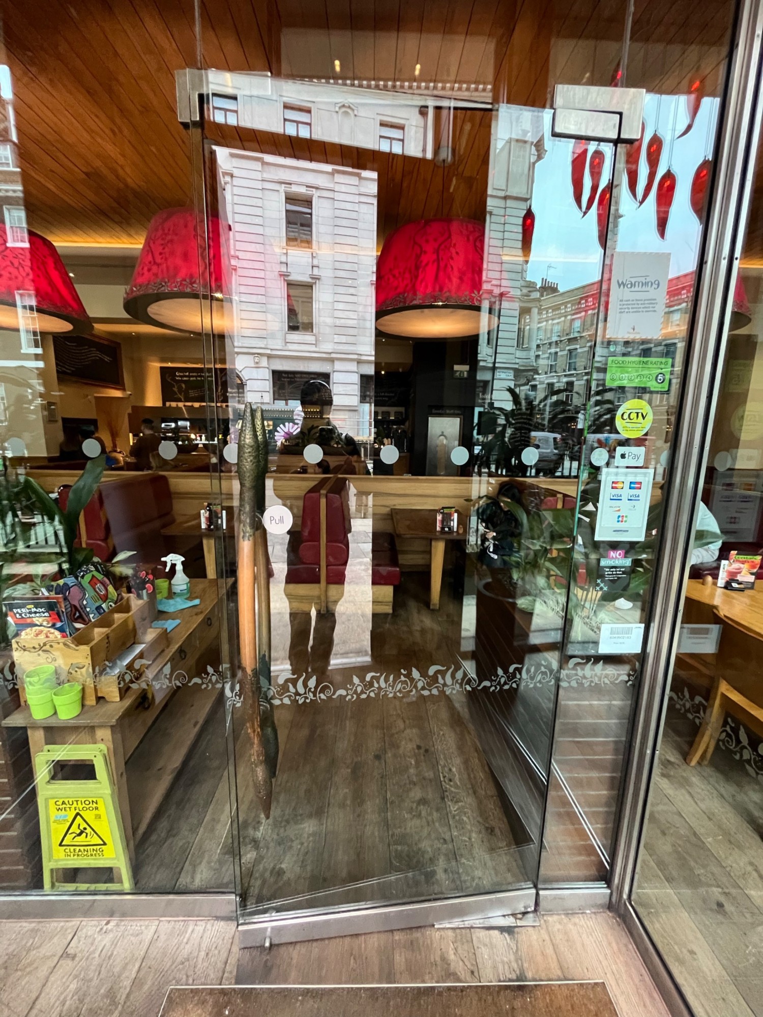 From door facing straight. Glass door ahead. Pull open via handle on left side.