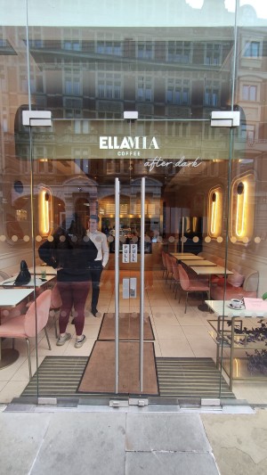 Glass double doors ahead. Pull open via vertical handles in centre.
