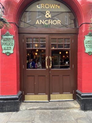 Glass doors with brown frame. Golden, metal handle in middle. Pull to open.