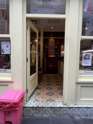 Entrance into venue: one large step. One manual glass door kept open, handle on the right