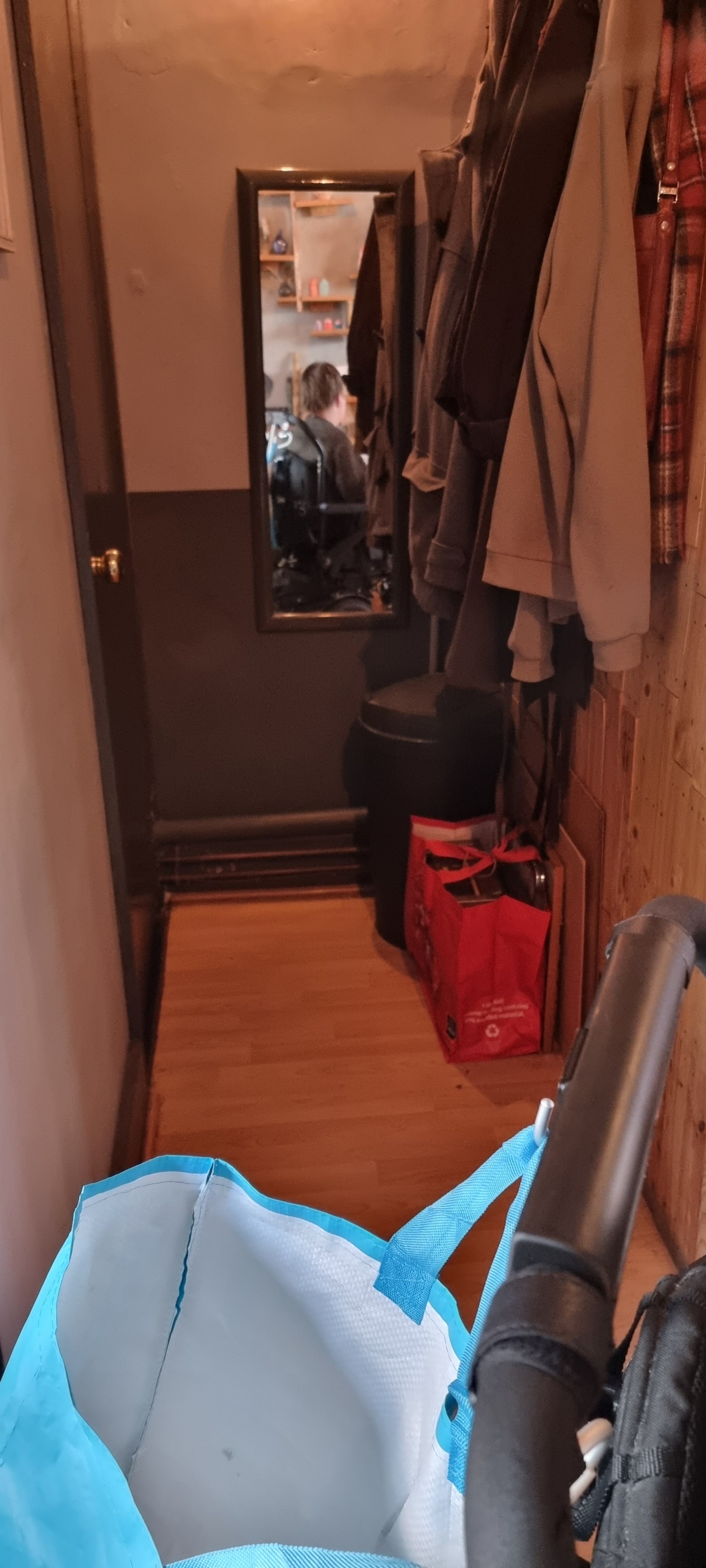 Narrow doorway and corridor down to bathroom