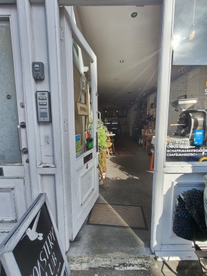 White framed glass door. Push silver handle on right to open.