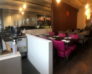 View from the entrance. Straight ahead there is low countertop and turning right the pathway to the rest of the venue.