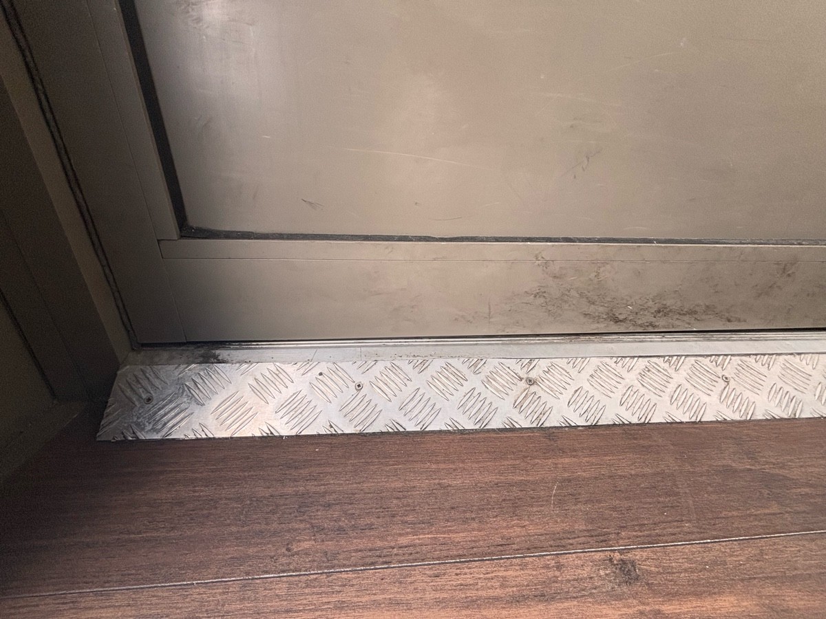 Large metal bump at foot of door.
