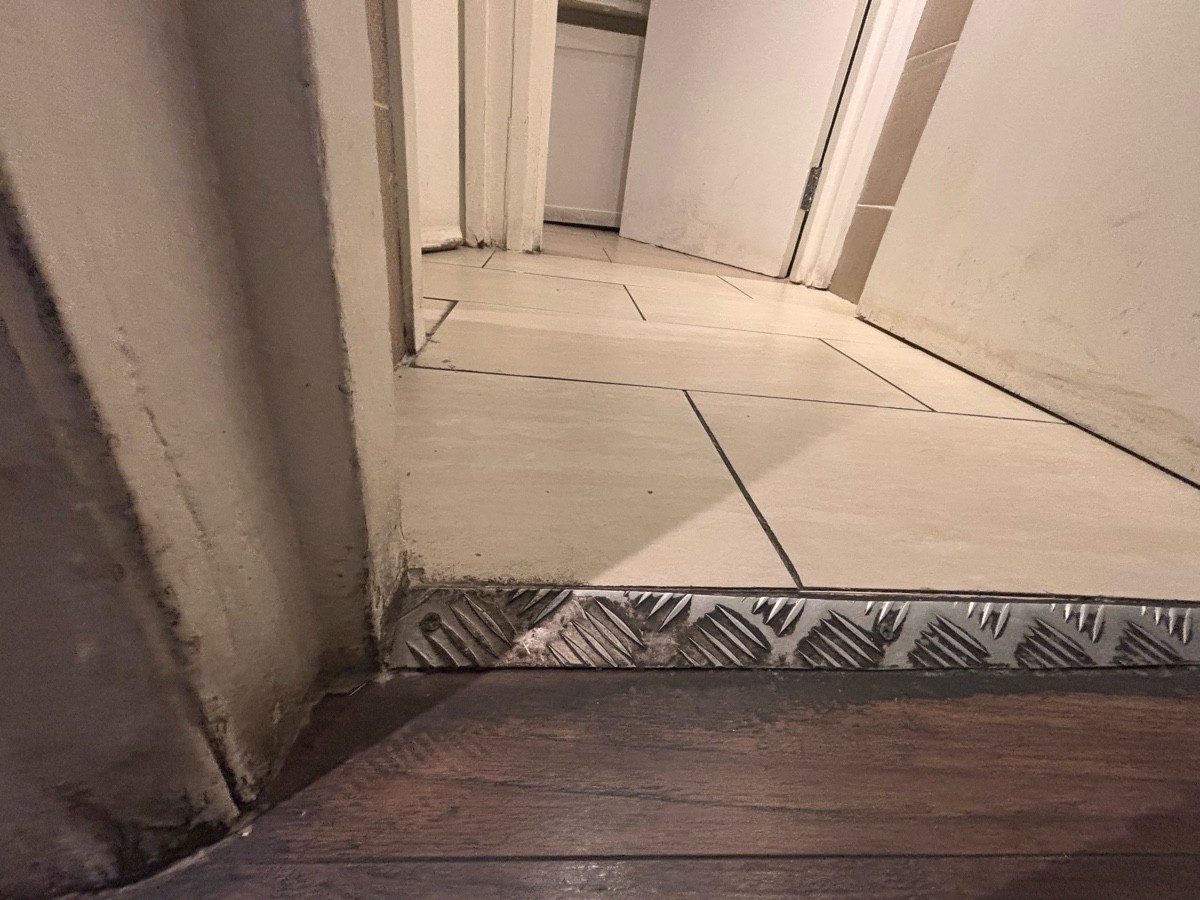 Small metal bump at foot of door.
