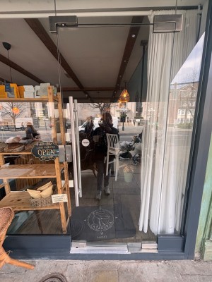 Glass door. Push metal handle from left to open.