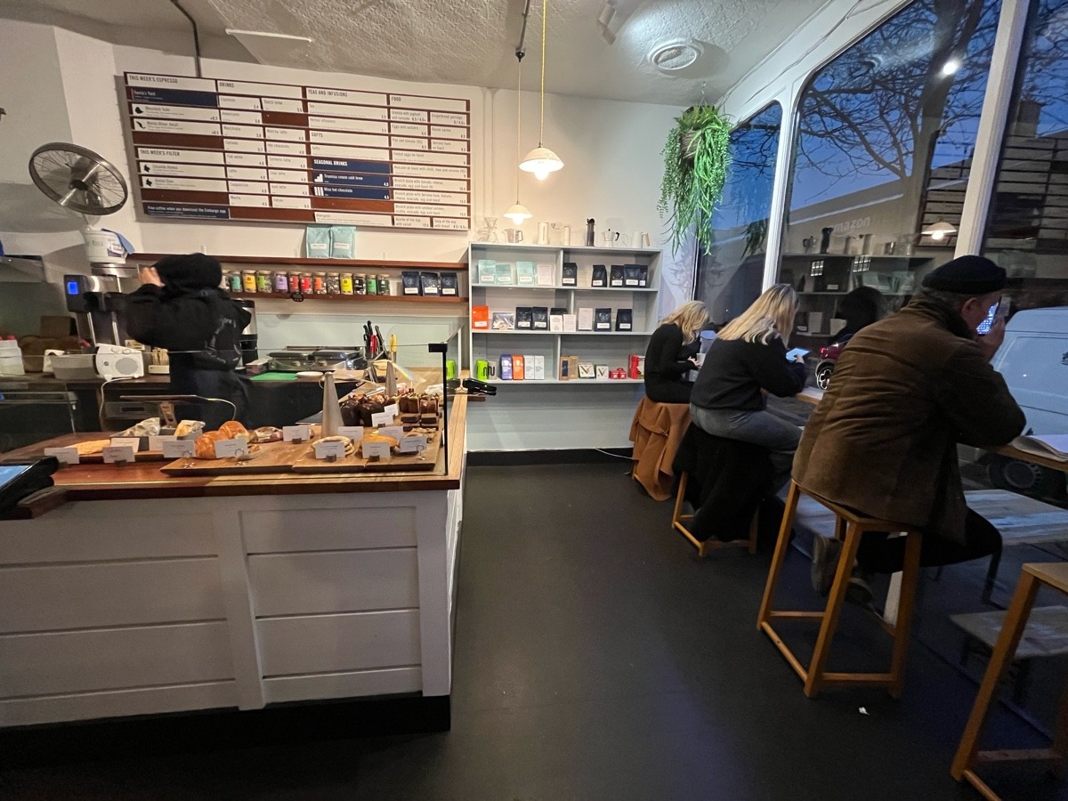From entrance facing right. Service counter to left. High table with backless stools along right wall