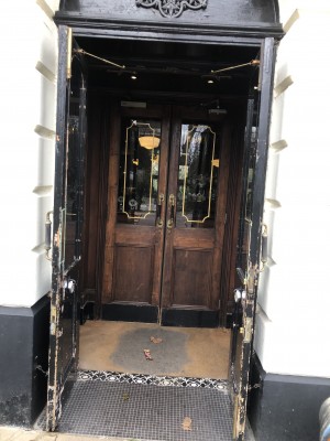Photo of main entrance. Push in middle to open first set of doors, and pull handles in middle to open the second set.