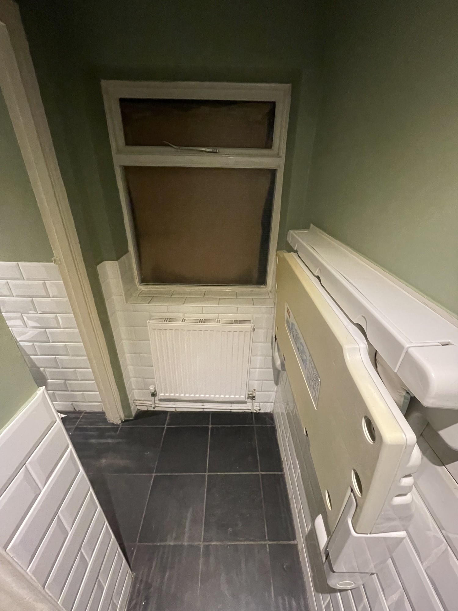 Ladies room view from turning left upon entering second preceding door. On the wall to the right is a baby change facility. If turn left at end of corridor there is a bathroom cubicle.