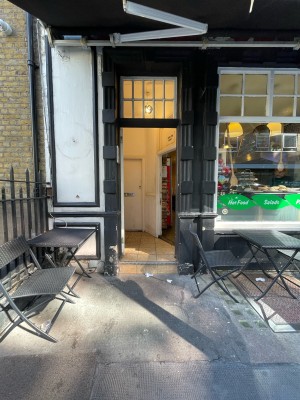 Path ahead, going straight. One step at end of path. First door immediately after step. White wooden door. Push silver handle at centre to open.