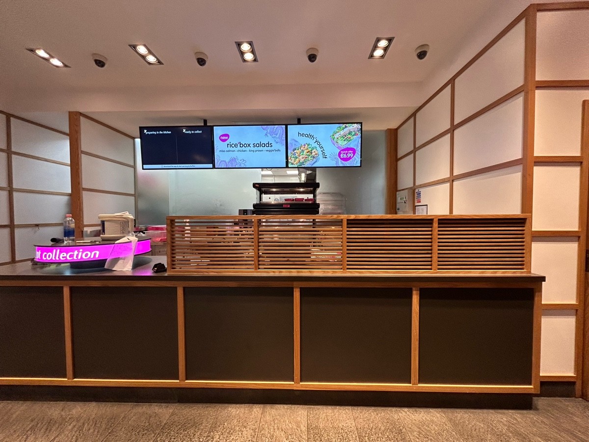 From end of order screens facing straight. Collection counter along back wall.