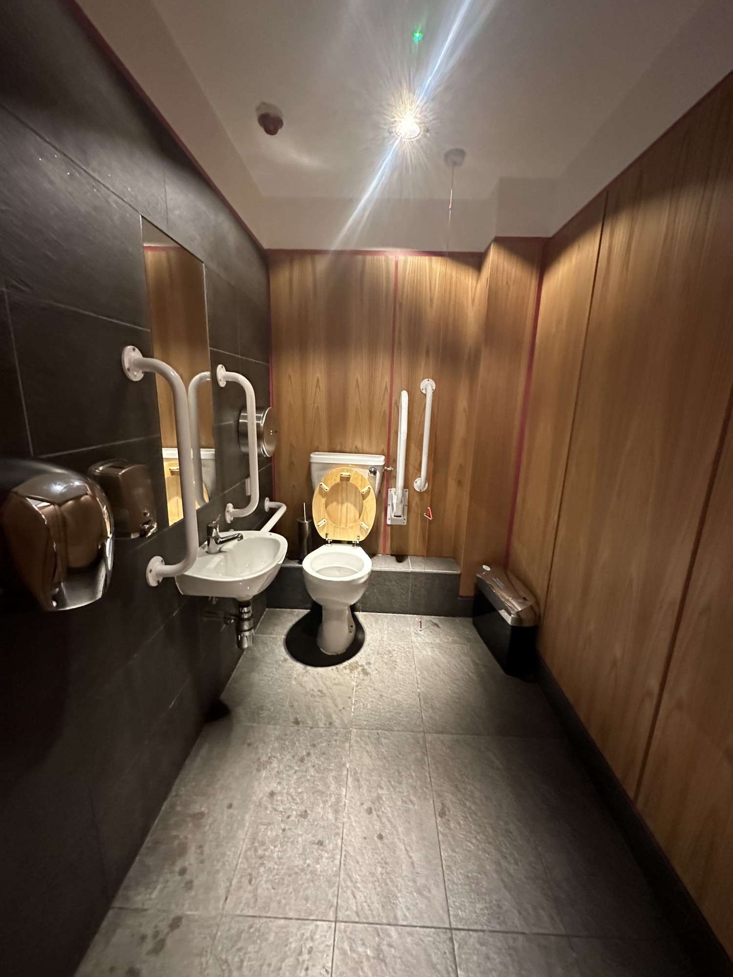 View of the bathroom from the entrance. The wc is located on the left hand side and after it against  to the left wall the sink is located.