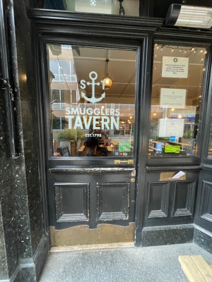 Wooden glass door with handle at right, push to open.