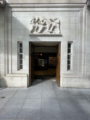 Facing entrance. Wooden door ahead. No handles. Doors open from inside.