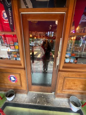 Wooden glass door with handle at right, push to open.